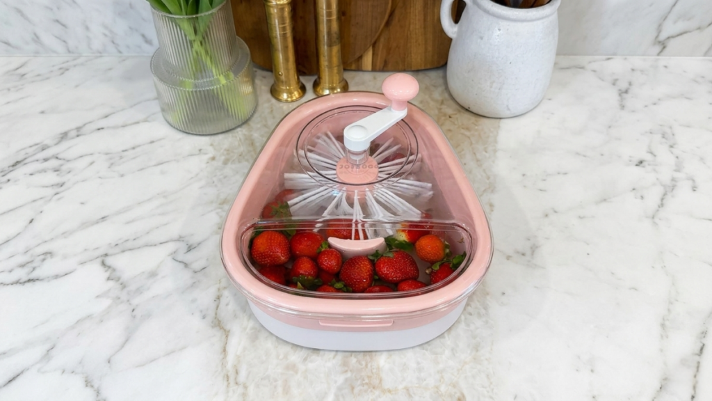 Fruit washer and salad spinner with strawberries on a marble kitchen countertop